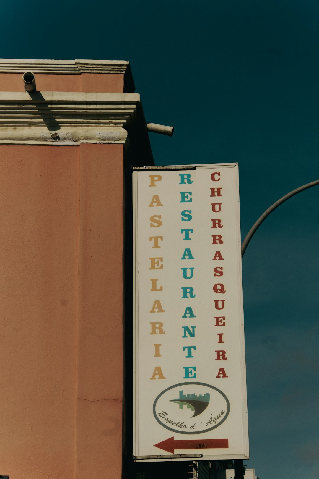 restaurant-sign-in-the-street-with-colorful-words-jfqlobhcuc